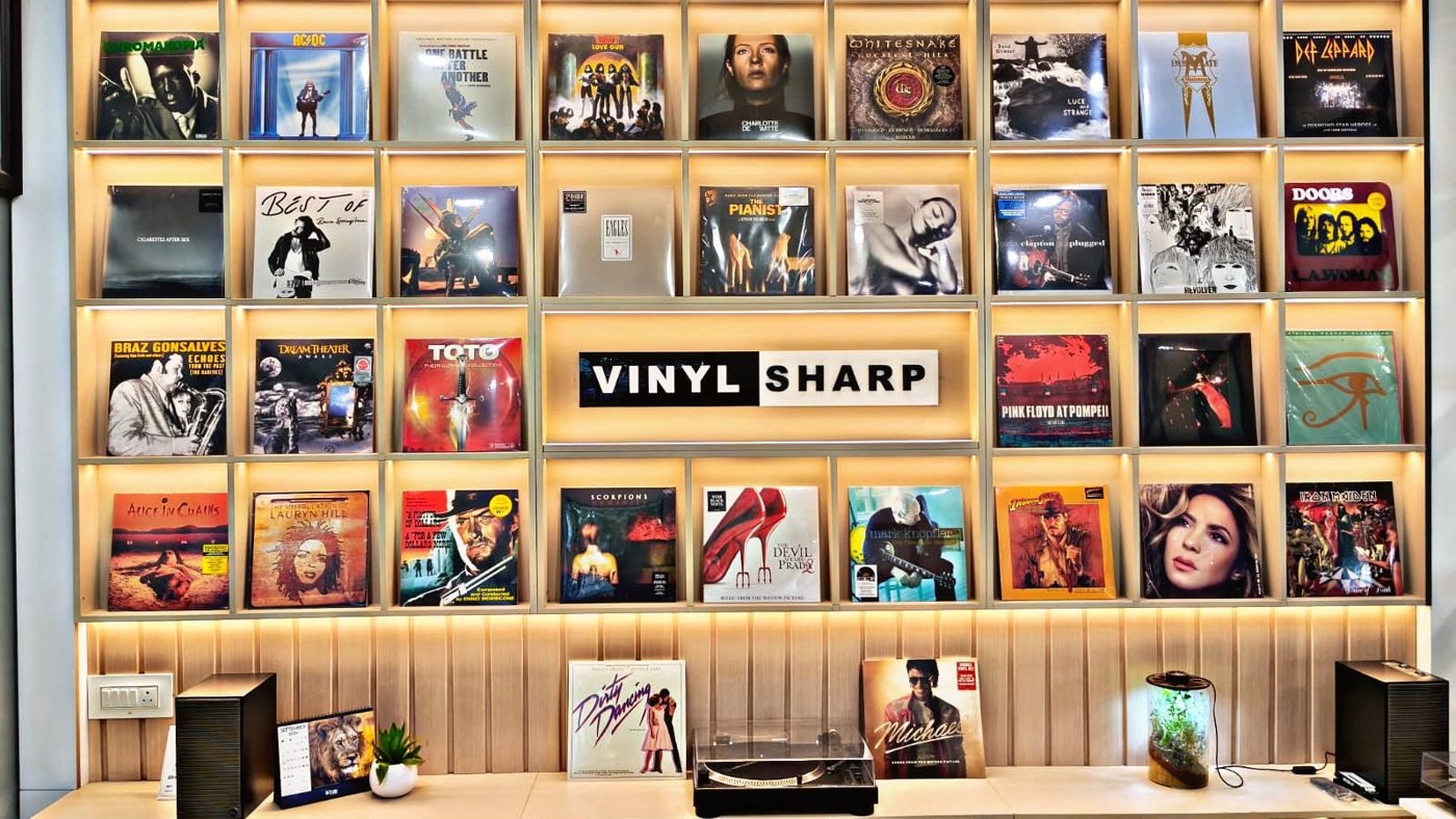 The Vinyl Sharp record wall, shelves of curated vinyl beneath the Vinyl Sharp sign